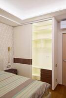 Modern bedroom interior with a builtin wardrobe and soft, inviting lighting for warmth photo