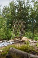 A Serene and Beautiful Garden Landscape Featuring a Decorative Trellis and Natural Elements photo
