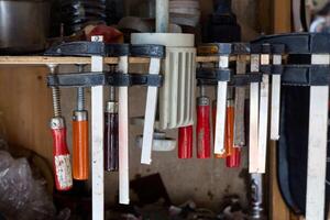 A variety of assorted hand tools elegantly arranged and hanging in a functional workshop photo