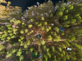 An Aerial Perspective of a Serene and Peaceful Forest Retreat Surrounded by Tranquil Water photo