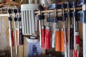 A variety of assorted clamps and tools are found in a wellequipped workshop setup photo