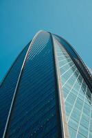 A Stunning Modern Skyscraper Perspective Set Against a Bright, Clear Blue Sky Background photo