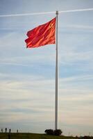 A grand and impressive Flag of China billows majestically against the expansive sky above photo