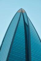 The Stunning and Beautiful View of a Modern Skyscraper Standing Tall Against a Clear Sky photo