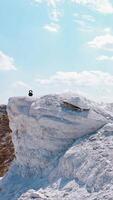 Man Resting After Workout. Aerial view of athletic man resting after hard training in the mountains. Vertical video