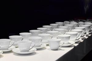 An Array of Elegant White Coffee Cups Beautifully Arranged on Display for All to Enjoy photo