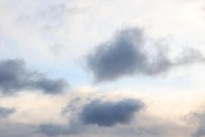 An exceptionally serene sky adorned with gentle clouds in delightful soft hues throughout photo