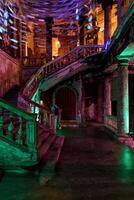 Experience the Haunting Elegance of an Abandoned Staircase illuminated by Dramatic Lighting photo