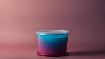 A plastic container with a lid on a pink background photo