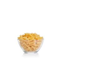 Pasta products in the form of a spiral on a plate, texture, on a white background photo