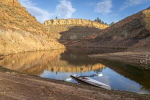 coastal sculling shell in sandstone canyon of Horsetooth Reservoir in Colorado in fall scenery photo