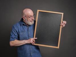 senior man, teacher, mentor or presenter, with blank blackboard, education, presentation and business communication concept photo