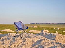 empty folding chair in middle of nowhere photo