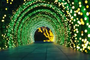 Enchanting illuminated tunnel creating magical Christmas atmosphere for evening strolls. photo