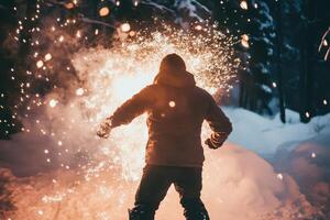 A man is standing in the snow with sparks coming out of his hands photo
