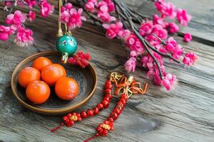 A bowl of eggs and a branch of pink flowers photo