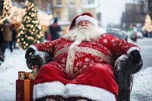 Santa claus sitting in a chair on a snowy street photo