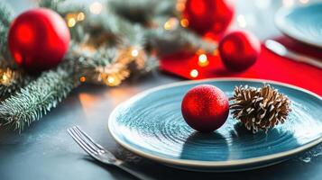 A plate with two red balls and a pine cone on it photo