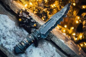 A knife laying on the ground near a christmas tree photo