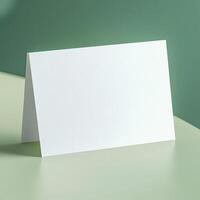 white greeting card on a display product mockup pastel green background photo