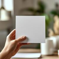hand holds up a blank paper photo