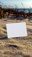 mock up blank white postcard laying in sand photo