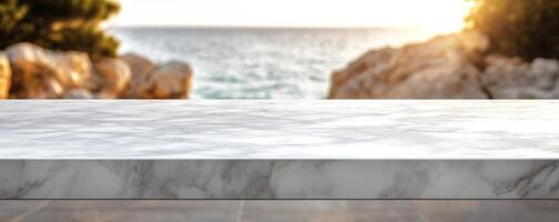 Natural Marble Surfaces with Soft Bokeh Lighting. A serene coastal scene featuring a marble countertop overlooking the sea, illuminated by the warm glow of sunset. photo