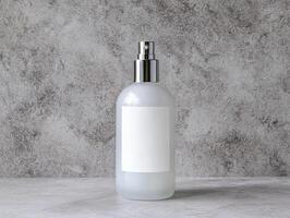 Sophisticated Spray Bottle Designs. A minimalist spray bottle with a blank label sits against a textured gray background, ideal for product branding or cosmetic uses. photo