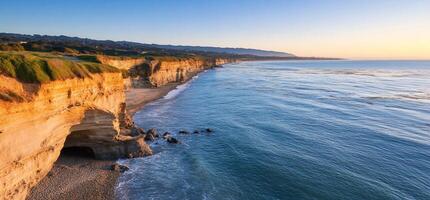 Scenic coastal view with cliffs and calm ocean at sunset. photo