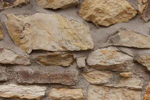 Stone wall showing rough surface texture background in Vysehrad Prague photo