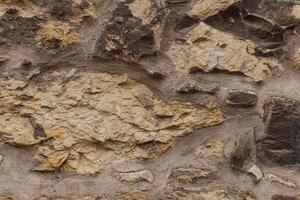 Rough textured stone wall forming a solid background in Vysehrad Prague photo