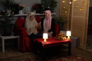 Two women sitting on a couch photo