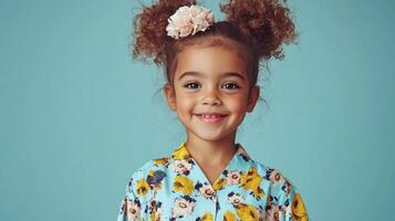 A joyful girl with curly hair and a flower accessory enjoys a moment, displaying a cheerful smile and bright attire photo