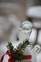 a small glass figurine with a red ribbon photo