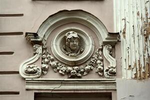 a decorative face on the side of a building photo