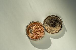 Broken palette with highlighter on a white table. Decorative cosmetics photo