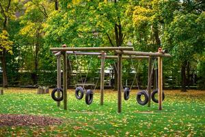 View of a swing made from car tires on a playground photo