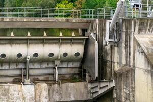 View of a closed spillway on a small dam on a river photo