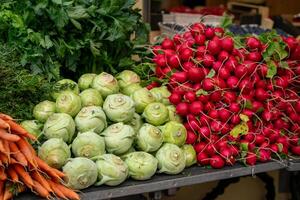 Various stacks of vegetables lie on the table for sale at the market photo