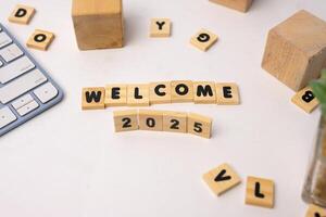 wooden blocks says welcome 2025 and another blocks around it photo