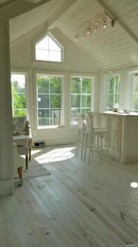 A white kitchen with a large window photo