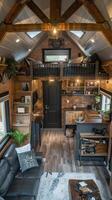 The tiny house is filled with furniture and a loft photo