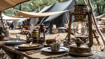 An old lantern is on a table with a tablecloth and plates photo