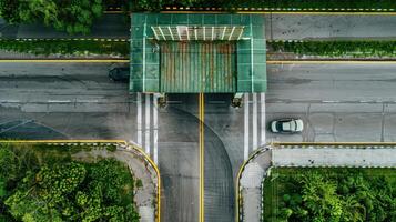 An overhead view of a road with a car driving on it photo