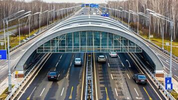 Cars drive on a highway under an overpass photo
