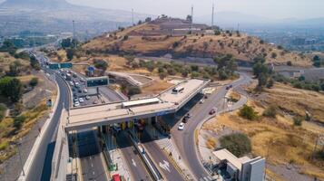 A highway with a toll booth and a mountain in the background photo