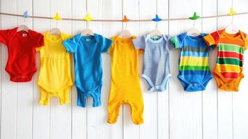 Baby clothes hanging on clothes line photo