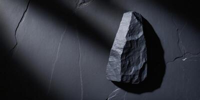 A large rock on a wall with shadows photo