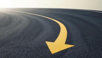 A yellow arrow pointing to the future on an empty road photo