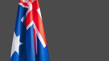 Close-up of the Australian flag is on the left side on a gray background photo